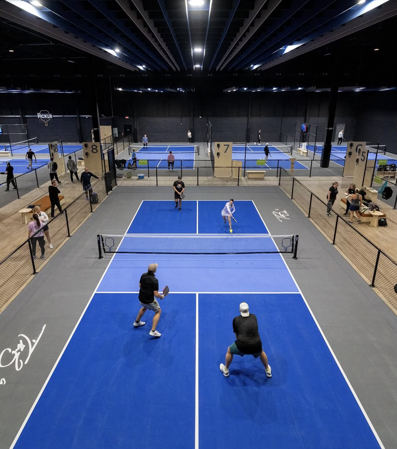 Indoor PICKLR facility with multiple courts and active players